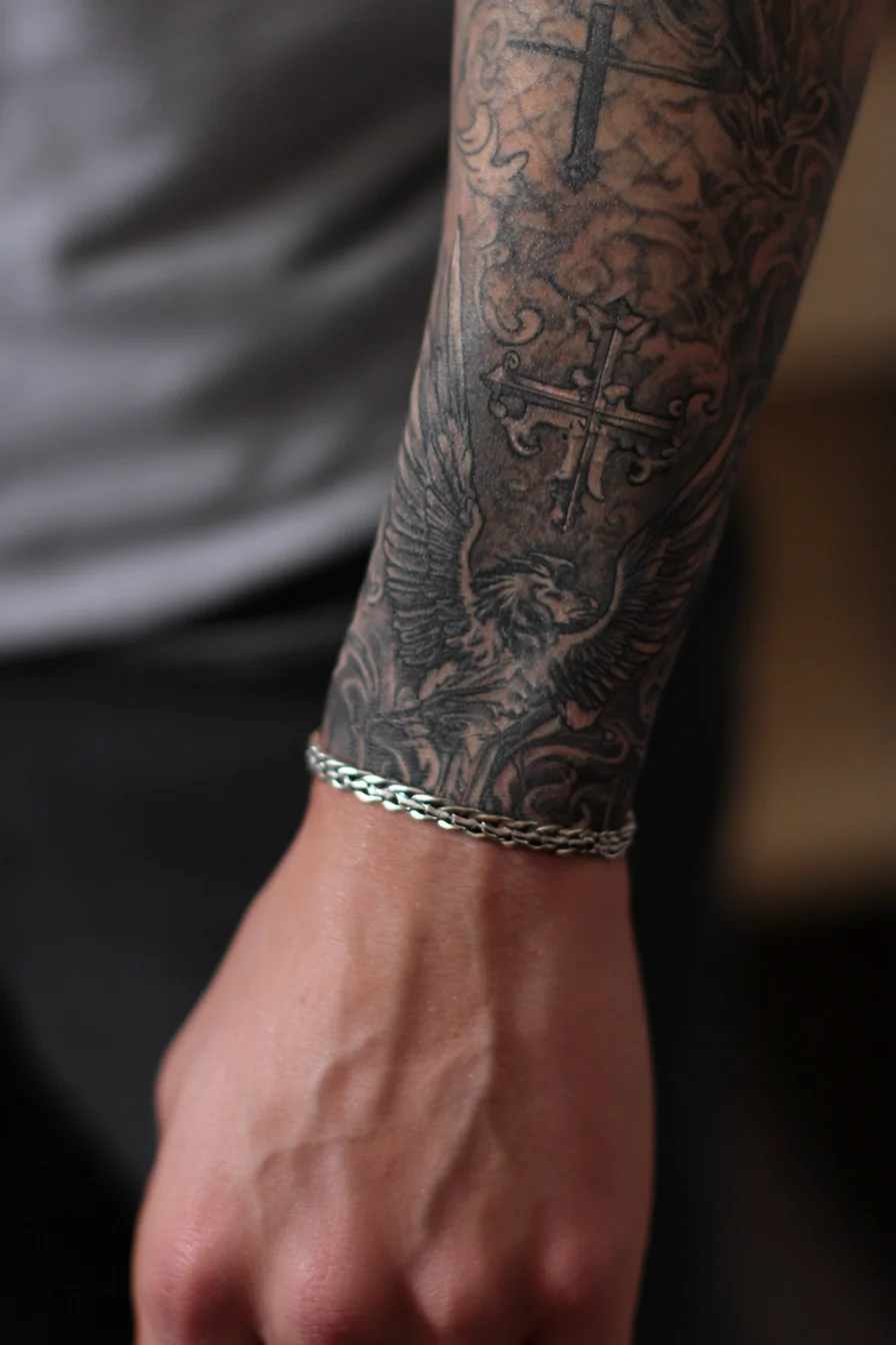Black-and-Grey Winged Lion with Cross — Forearm Sleeve Tattoo
