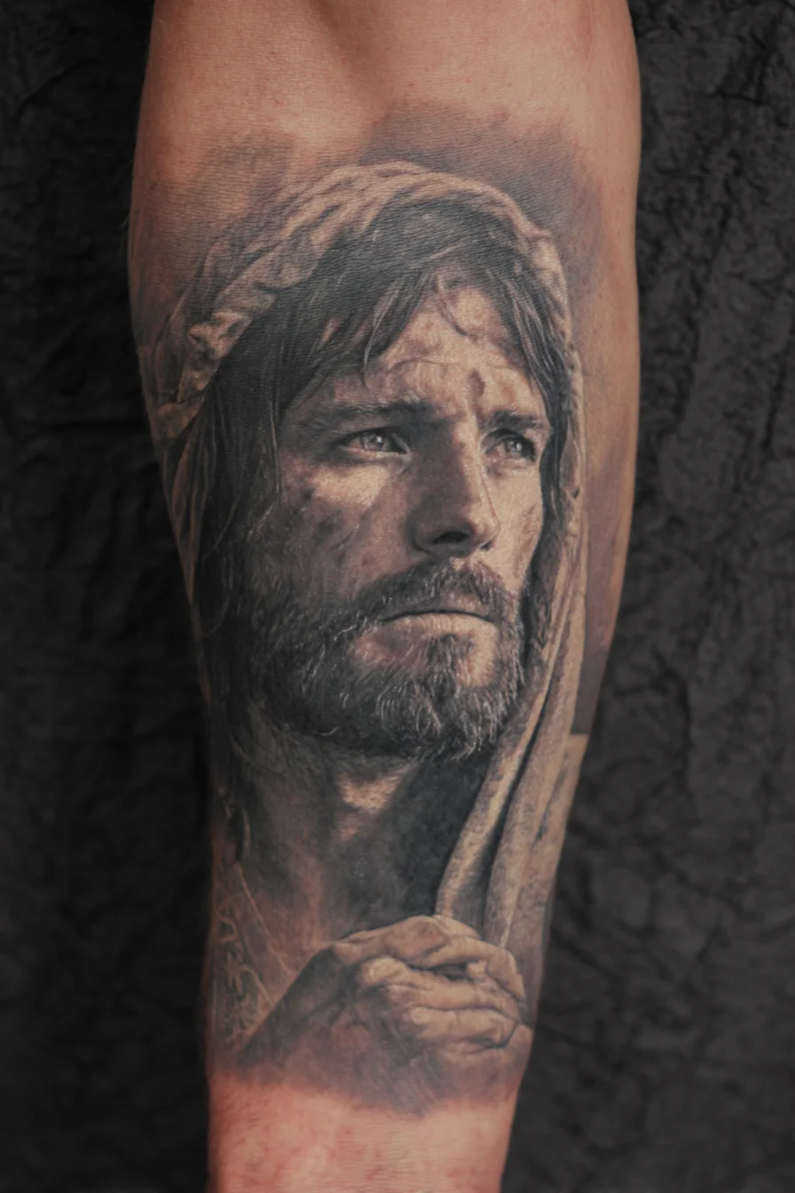 Realistic Hooded Bearded Male Portrait — Black & Grey Forearm Tattoo